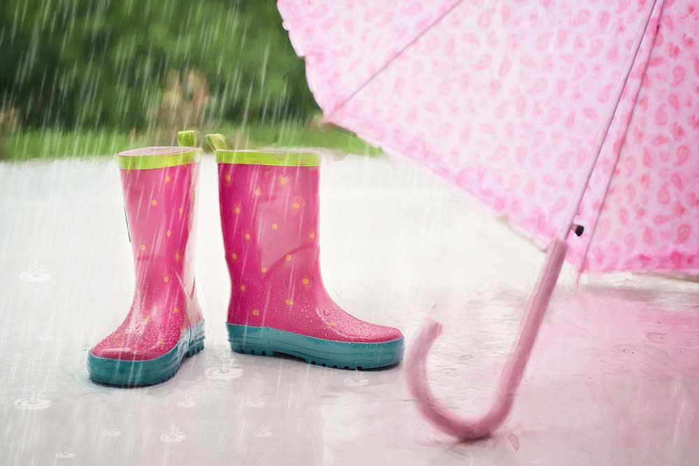 pink rain boots and umbrella